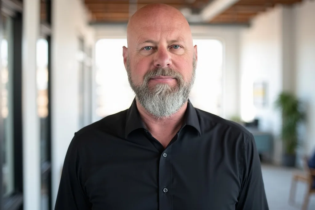 Joe Cook in a black shirt in an open office